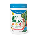 Progressive VegeGreens Strawberry Banana - A close-up of the container of Progressive VegeGreens Strawberry Banana next to a glass of green smoothie.