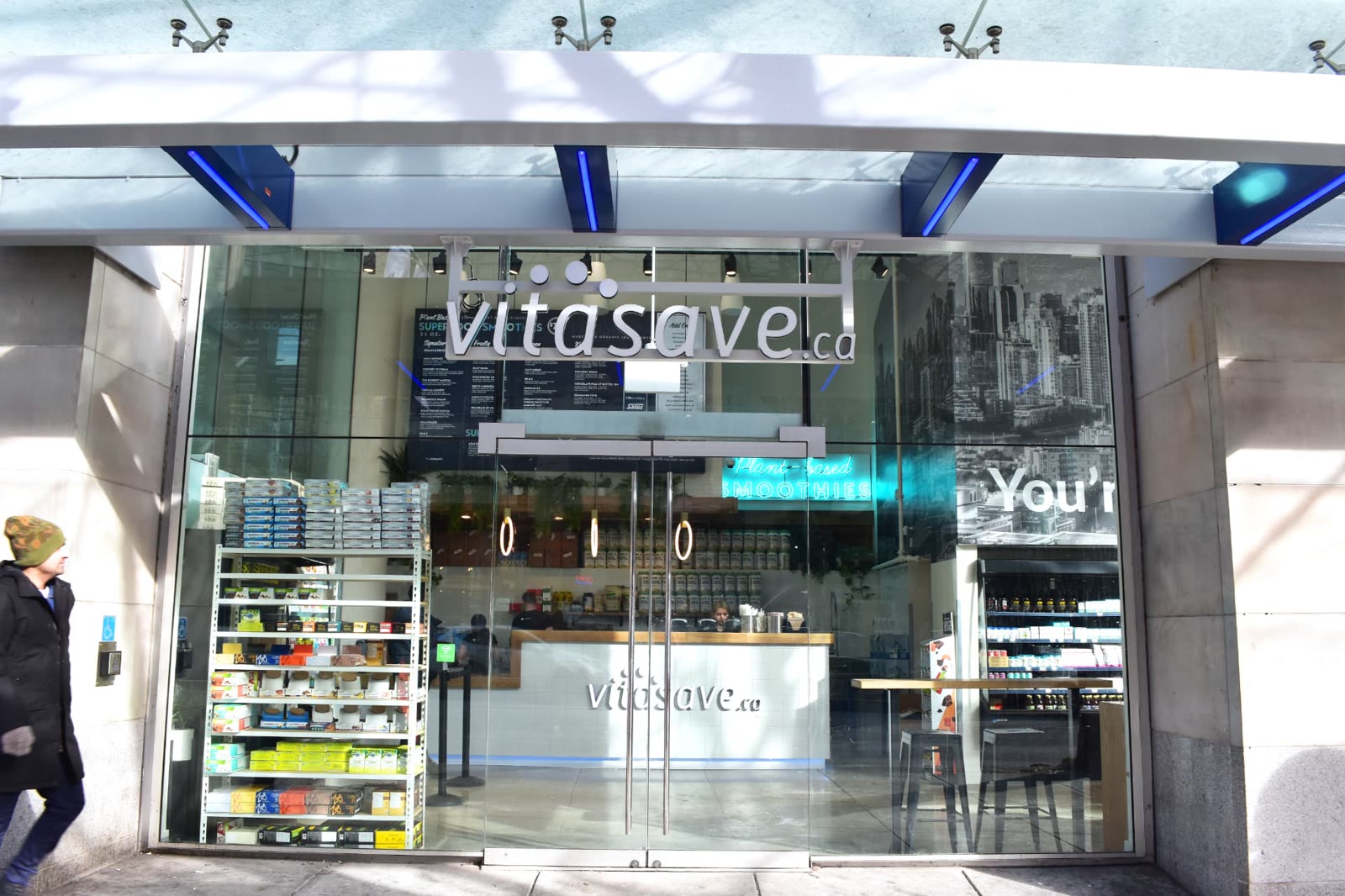Vitasave Robson storefront exterior at 551 Robson Street, Vancouver, with the Vitasave sign above the glass entrance