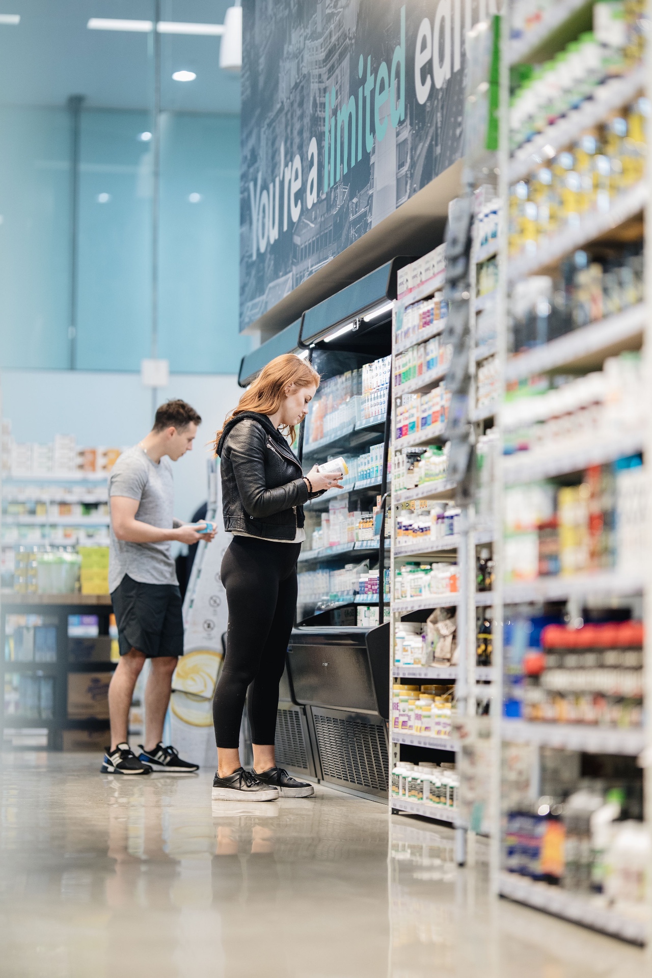 Team member arranging supplements on store shelves