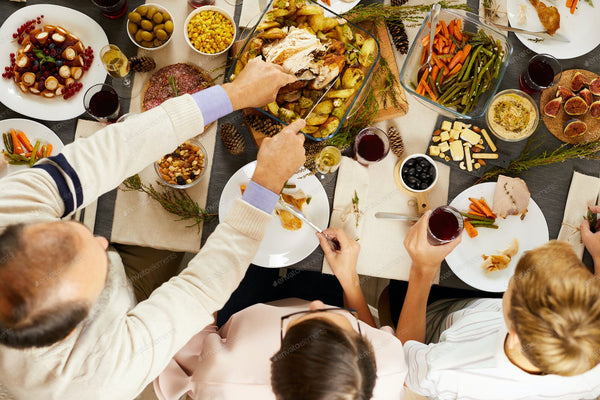 Enzymedica supplements placed on a holiday table to support digestion and reduce bloating after festive meals.