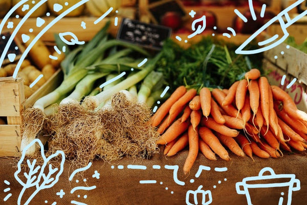 Colorful autumn vegetables like squash and carrots roasted in a baking dish