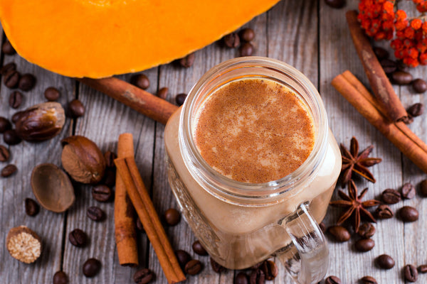 Warm up with Vitasave's 5 new hot superfood elixirs in colorful mugs, surrounded by fresh natural ingredients for a cozy and healthy boost.