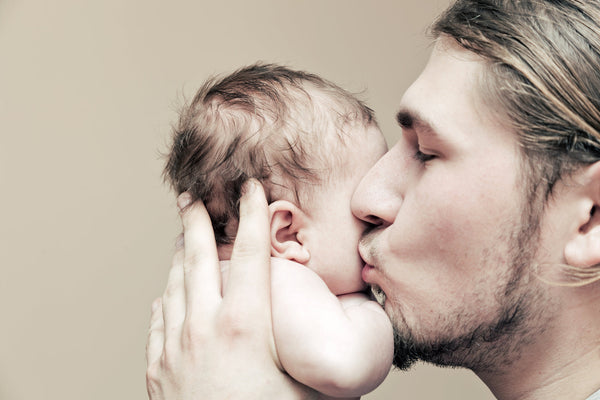 Assortment of healthy Father’s Day gift ideas including supplements, protein powder, skincare products, and natural wellness items arranged in a gift box with a card that reads 'Happy Father’s Day’.