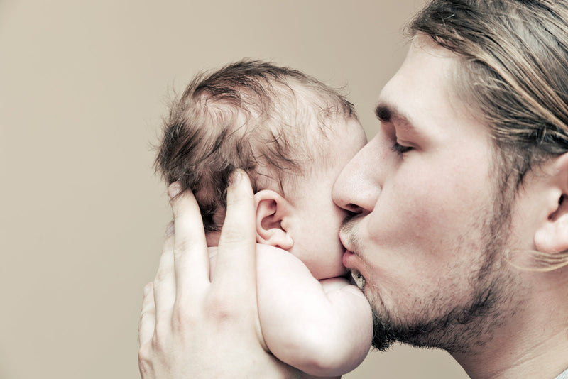 Assortment of healthy Father’s Day gift ideas including supplements, protein powder, skincare products, and natural wellness items arranged in a gift box with a card that reads 'Happy Father’s Day’.