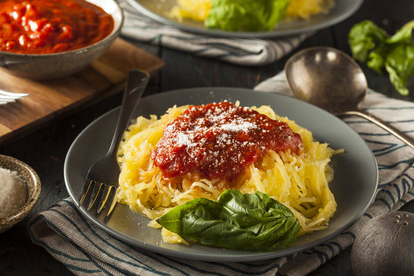 Delicious low carb spaghetti squash recipe served with fresh herbs and vegetables