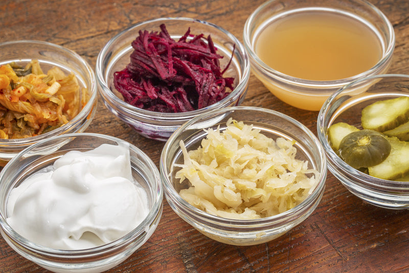 Colorful jars of fermented vegetables showing gut health benefits from fermented foods