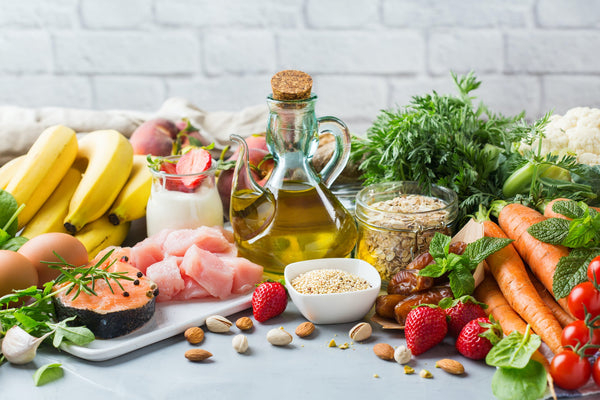 Illustration showing heart health benefits of the Mediterranean diet with fresh vegetables, olive oil, fish, and whole grains.
