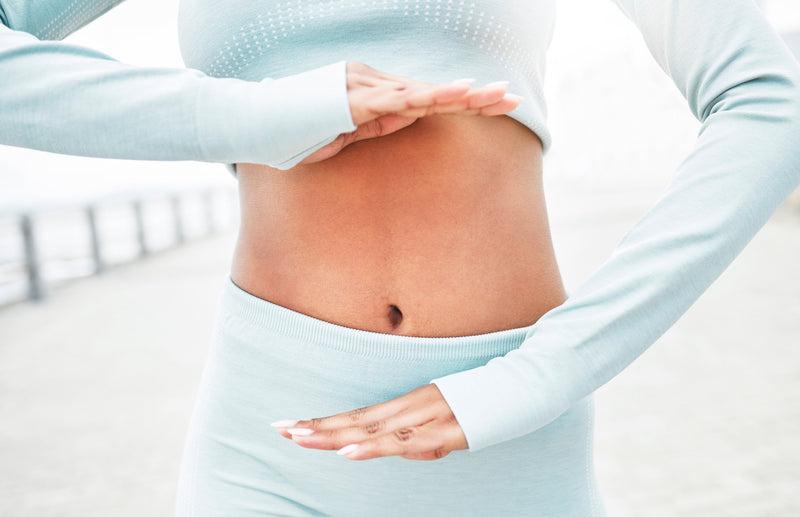 A close-up of a variety of fiber-rich snacks like nuts, seeds, and dried fruits arranged alongside a bottle of probiotic capsules, symbolizing natural ways to support digestive health and overcome digestive issues. 