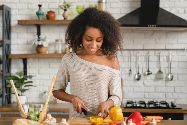 Fresh assortment of colorful plant-based foods including leafy greens, legumes, whole grains, nuts, seeds, and fresh fruits arranged on a wooden table, representing essential tips for balanced vegan and vegetarian diets.