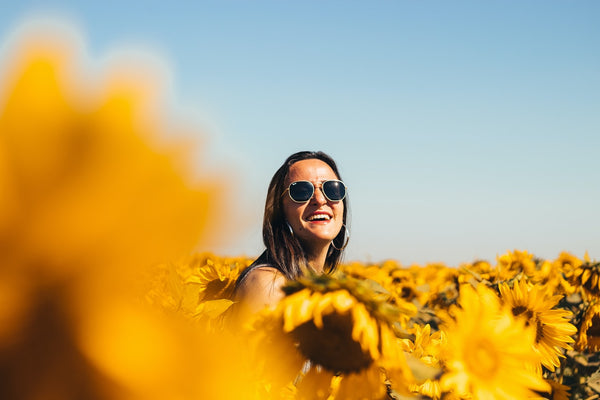 Woman applying sunscreen on her face before enjoying a sunny outdoor day