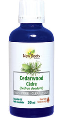 A blue bottle labeled 'New Roots Cedarwood (Cedrus deodara) Essential Oil, 30 mL.'