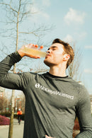 A close-up of No Days Wasted Hydration Replenisher bottle with morning sunlight.