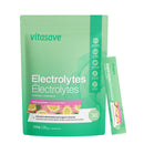 A package of Vitasave Electrolytes with one sachet partially pulled out to display the powder inside. The packaging is green with images of fruits, indicating the flavor of the electrolyte supplement.