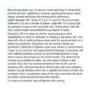 Scoop of Genuine Health Greens+ Extra Energy Natural Cappuccino powder next to the 441 g container on a wooden surface.