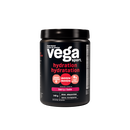 Vega Sport Electrolyte Hydrator Berry tub on a gym bench with sports equipment in the background.