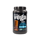 Athlete holding a Vega Sport Protein Chocolate container after a workout.