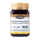 A jar of Flora Manuka Honey Blend with a label indicating it is MGO30+ honey, produced in New Zealand, and has various quality certifications including non-GMO and sustainable sourcing.