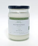 Glass jar of Nutritional Wellness Beef Tallow Suet, made from 100% grass-fed and grass-finished beef, placed on a rustic wooden counter with natural lighting.