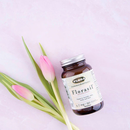 Lifestyle image of Flora Florasil 4.7 mg VCaps placed on a natural background with fresh herbs and leaves.