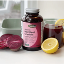 Flora Organic Red Beet Crystals 200g container displayed alongside fresh organic beets, illustrating the product's farm-to-table purity and nutrient-rich content.