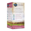 Close-up of two vegan tablets from Garden of Life Organics Women's Multi 40+ placed on a wooden surface, showcasing their natural, clean appearance without artificial additives.