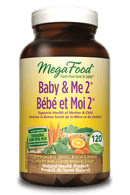 Close-up of MegaFood Baby & Me 2 tablets next to a glass of water, highlighting a prenatal vitamin designed for expecting mothers.