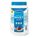 A plastic container of Progressive brand Grass-Fed Whey Protein in Chocolate Velvet flavor, with a blue lid and label showing the product name and chocolate pieces on the front.