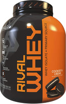 A container of Rivalus Rival Whey Protein Powder in the flavor Cookies & Crème. The packaging is primarily black and orange with product information displayed.