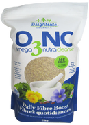 Close-up of Omega 3 NutraCleanse Organic Flaxseed Fiber Supplements capsules alongside flaxseeds and a measuring spoon.